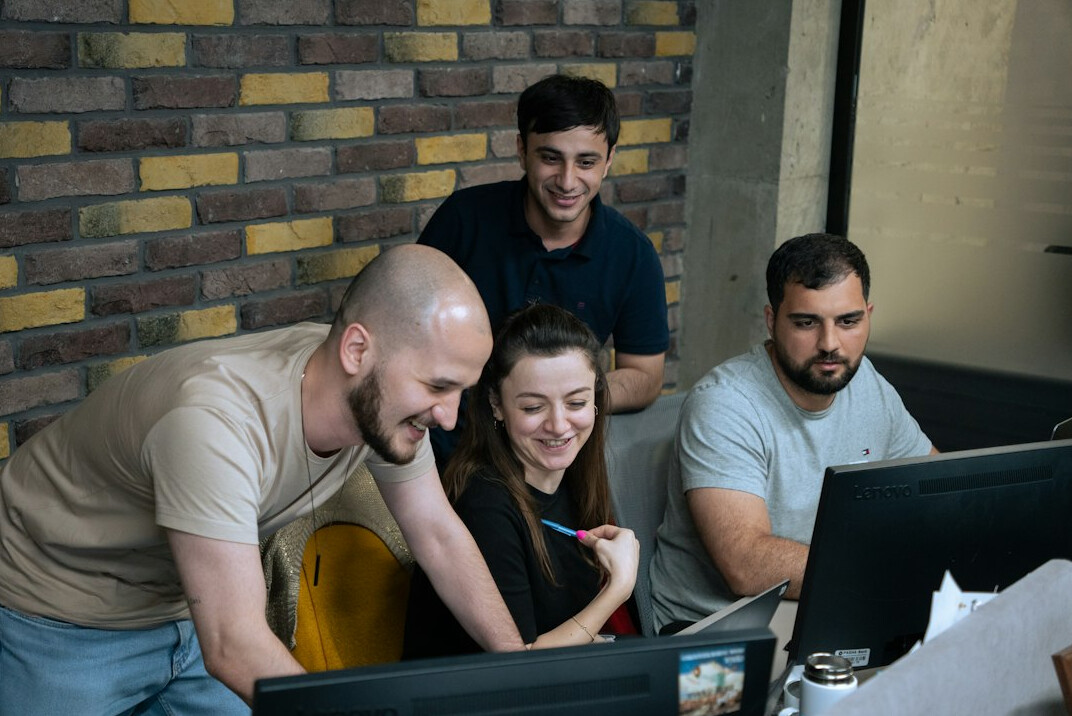 team of programmers collaborating in office